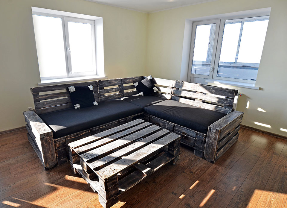 Угловой диван из поддонов черный матрас и стол