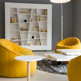 Желтая мебель в комнате с серыми стенами
