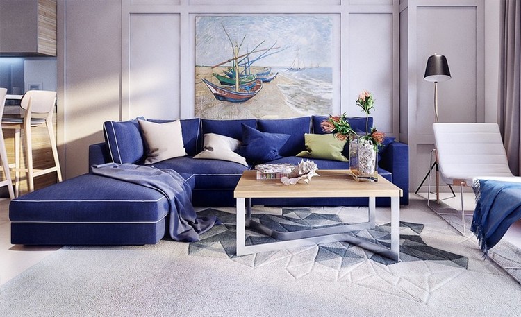 Синий угловой диван в интерьере гостиной совмещенной с кухней
