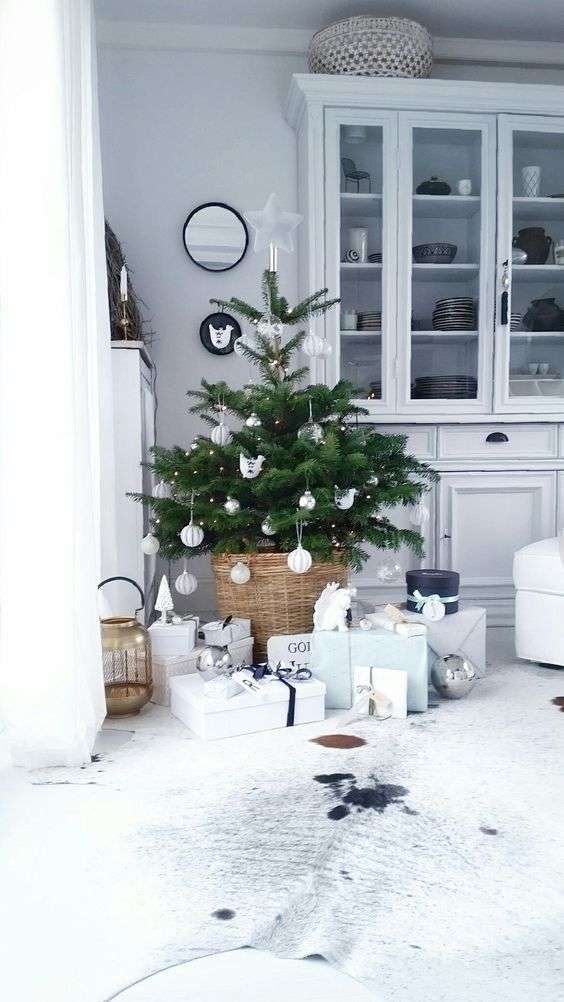 02-a-small-nordic-christmas-tree-with-lights-and-white-and-silver-ornaments-4556614