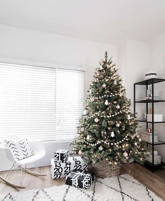 07-a-modern-scandinavian-tree-with-pompom-ball-garlands-metallic-ornaments-and-tree-shaped-ornaments-plus-lights-2189446