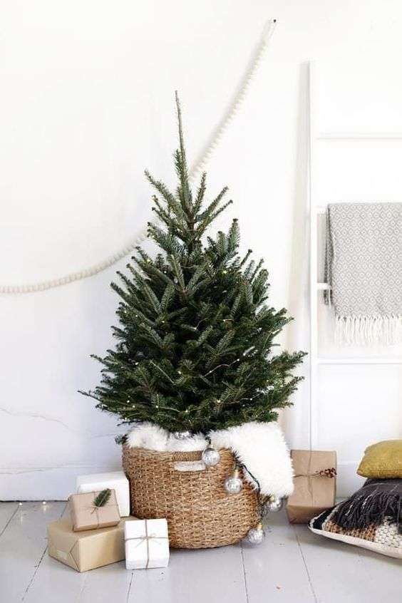 12-a-modern-nordic-tree-with-leds-in-a-basket-with-faux-fur-and-vintage-lights-hanging-down-5690129