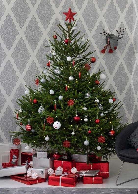 23-a-traditional-nordic-christmas-tree-with-white-silver-clear-and-red-ornaments-and-a-red-star-on-top-7479985